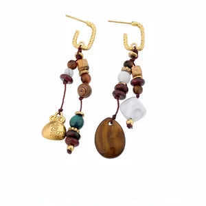 Retro ethnic style wood bead and resin drop earrings featuring golden fortune bag charm