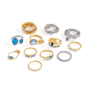 Collection of assorted blue zircon and pearl rings in gold and silver finish.
