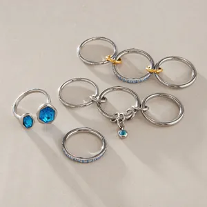 Detailed view of elegant stackable stainless steel rings with blue crystal stones