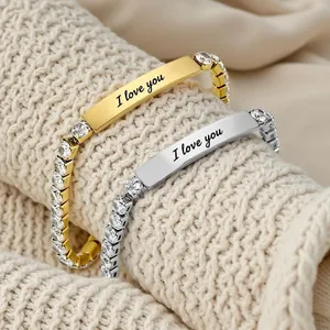 Close-up view of elegant gold and silver zircon bracelets with I love you engraving.