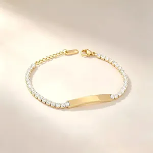 Detail of gold-plated stainless steel tennis bracelet with clear zircons and engravable ID bar