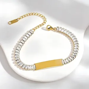 Detailed view of gold stainless steel bracelet with baguette zircons and engravable plate