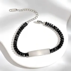 Detailed view of stainless steel bracelet with black zircons and engravable plate