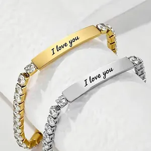 Close-up of gold and silver stainless steel bracelets with I love you engraving.