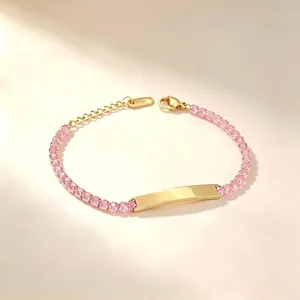 Detail view of gold-tone stainless steel bracelet with pink zircons and engravable bar