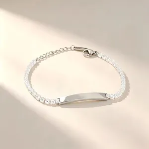 Close-up of stainless steel tennis bracelet with sparkling zirconia and engravable bar