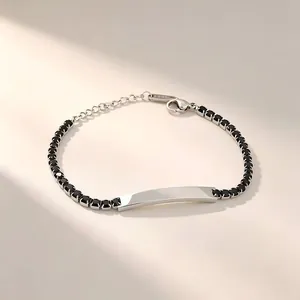 Elegant stainless steel tennis bracelet with black zircons and engravable ID plate detail
