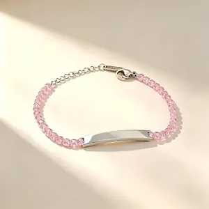 Detailed view of stainless steel bracelet with pink zircon beads and engravable silver bar.
