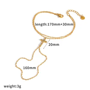 Elegante cadena de mano cruzada de acero inoxidable dorado con anillo de cristal