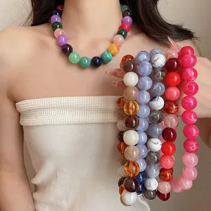 Detailed view of colorful dopamine-style acrylic beaded necklaces in multiple vibrant shades