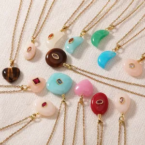 Detail shot of colorful resin geometric pendants on gold-plated stainless steel chains