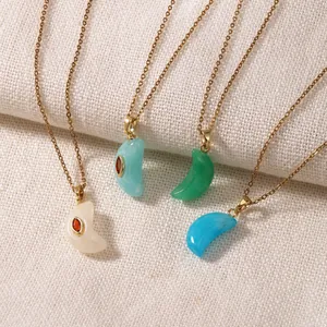 Detail shot of vintage resin moon pendants in four colors with gold stainless steel chains.