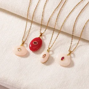 Detail view of vintage oval resin pendants with gold plated stainless steel chains