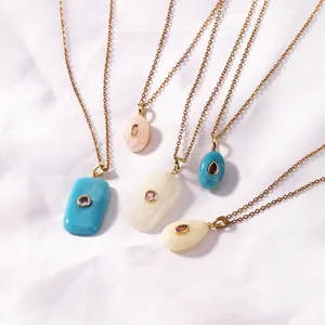 Close-up of vintage gold-plated necklaces with colorful resin geometric pendants