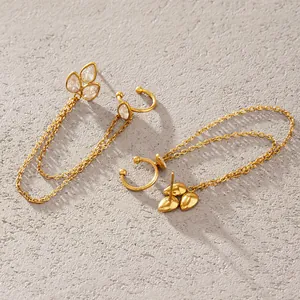 Close-up of gold titanium steel tassel earrings with ear cuff and crystal petals