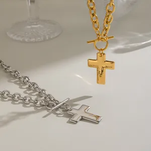 Detailed macro view of gold and silver plated stainless steel cross pendant necklaces