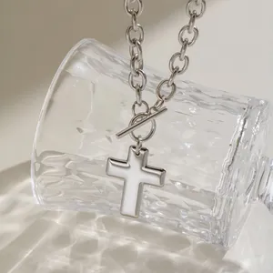 Close-up of stainless steel cross pendant necklace with a trendy toggle clasp