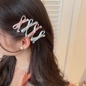 Zoete roze en blauwe satijnen strik haarspelden met strass-steentjes gedragen door model