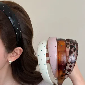 Detail view showing colorful rhinestone headbands in multiple styles and patterns