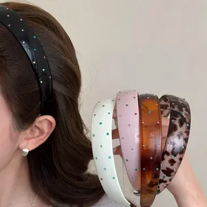 Detailed view of colorful rhinestone wide headbands in various colors and patterns