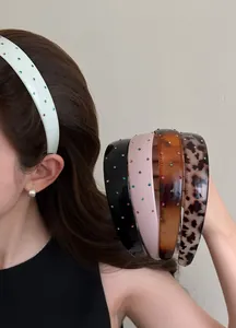 Detailed view of wide retro headbands with colorful rhinestones in multiple colors