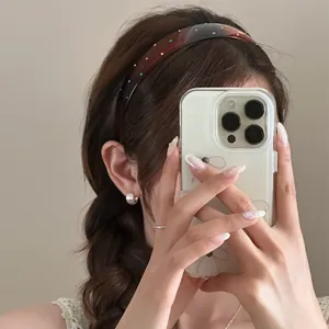 Detailed shot of a stylish brown headband with sparkling multi-color rhinestones.