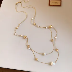 Detalle del collar francés de doble capa con perlas elegantes y cuentas doradas