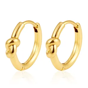 Detailed close-up of gold plated stainless steel knot hoop earrings on white background