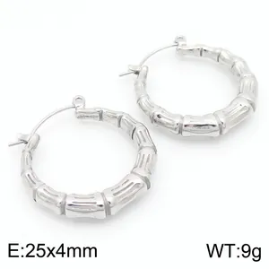 Macro view of silver bamboo-joint hoop earrings in titanium steel with measurements