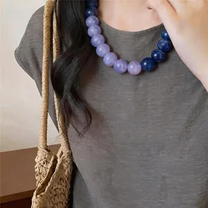 Close-up shot of a colorful purple and blue acrylic beaded necklace for vacation
