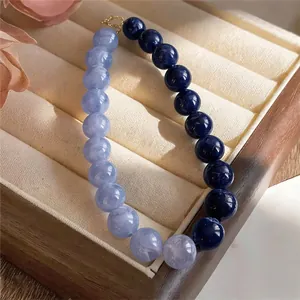 Close-up of blue and navy round acrylic beads on a stylish dopamine style choker necklace