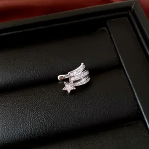 Close-up of silver star ear cuff with sparkling zircon on black leather display box