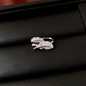 Detail view of sparkling zircon leaf-shaped ear cuff in silver finish finish.