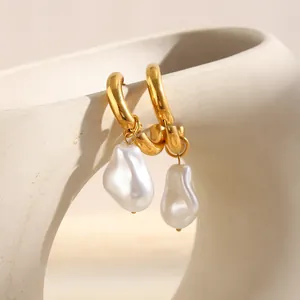 Detailed close-up of 18K gold-plated hoop earrings with elegant baroque pearls.