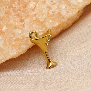 Close-up view of a 14K gold plated cocktail glass pendant charm with sparkling rhinestones