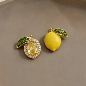 Asymmetric 14k gold plated lemon earrings with yellow crystal and enamel details