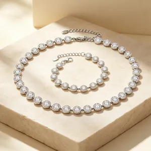 Elegant silver-toned jewelry set featuring pavé zircon halo necklace and bracelet details