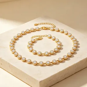 Detail view of gold-tone necklace and bracelet set with sparkling halo-set stones