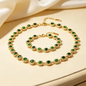 Detailed top view of a luxury green zircon jewelry set featuring gold necklace and bracelet