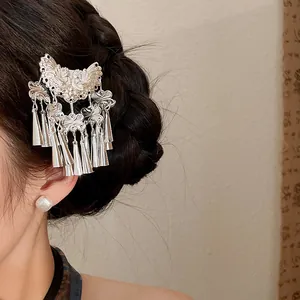 Macro view of vintage butterfly hair clip with long silver tassels for Hanfu styling