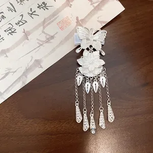 Detailed macro of a vintage silver butterfly and flower tassel hair clip for Hanfu.