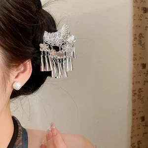 Detailed view of a retro silver flower hair clip with tassels for Hanfu outfits