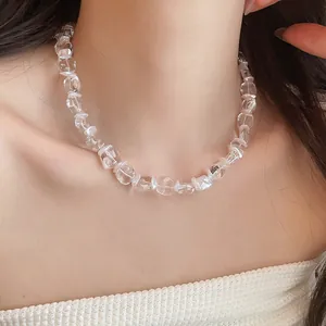 Gros plan d'un collier en perles de verre transparentes et perles sur le cou d'un mannequin
