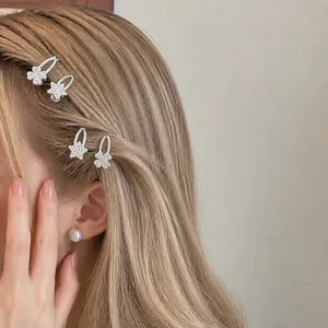 Elegante Haarklammern mit Strass-Sternen und Kleeblüten auf dem Haar des Models gezeigt