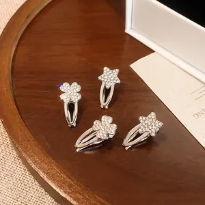 Detailansicht funkelnder Strass-Haarklammern mit Stern- und Kleeblatt-Motiv
