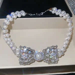 Dettaglio di una collana di perle vintage francese con fiocco in zircone luce