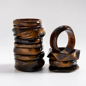 Detail view of vintage marbled resin bangles with geometric square and round shapes