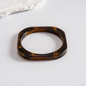 Detailed view of vintage square resin bangle with brown tortoiseshell marbled texture