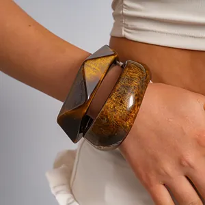 Close-up of retro marbled resin bangles with geometric square and rounded designs