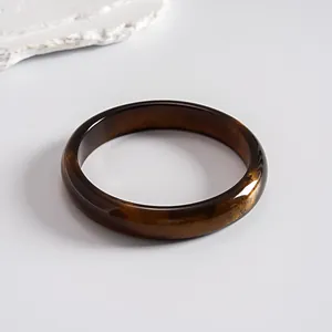 Detailed macro view showing the vintage amber-colored resin bangle with marbled dyed effect.